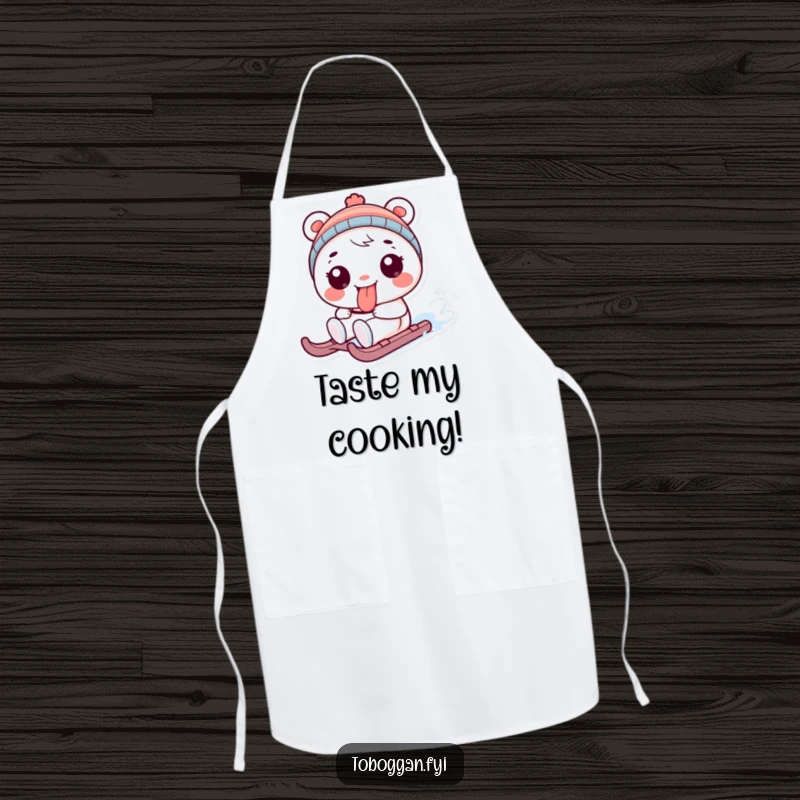 Funny apron with a playful character sticking its tongue out while sledding, a functional and humorous funny gift.