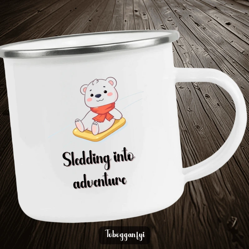 Funny Polar Bear Cub Camping Mug: A cheerful polar bear cub wearing a small scarf slides down an icy slope during an outdoor scene, adding winter fun.