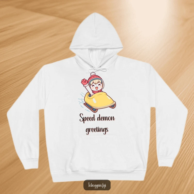 Funny hoodie with a character waving enthusiastically from a speeding toboggan, perfect for cozy, joyful winter days.