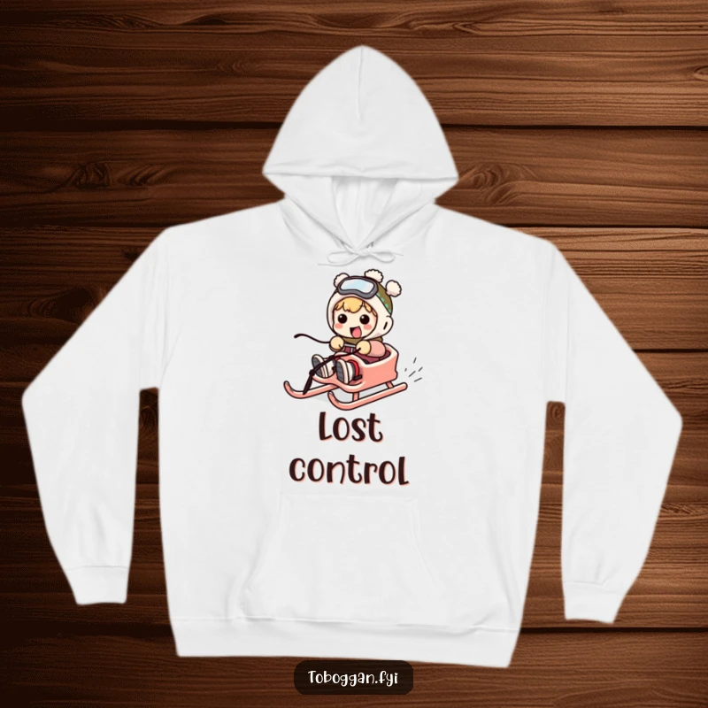 Funny hoodie depicting a character comically struggling to steer a sled, perfect for cozy winter humor.