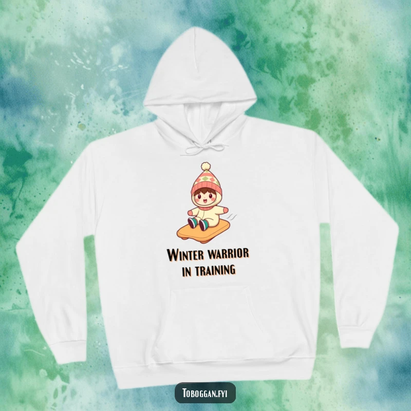 Funny hoodie showing a character in a silly hat, having a blast on a toboggan adventure down a snowy mountain.