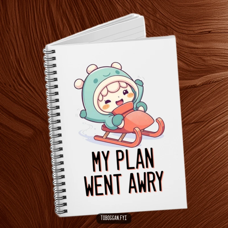Funny falling off sled notebook with a character making a silly expression while comically falling off a sled.