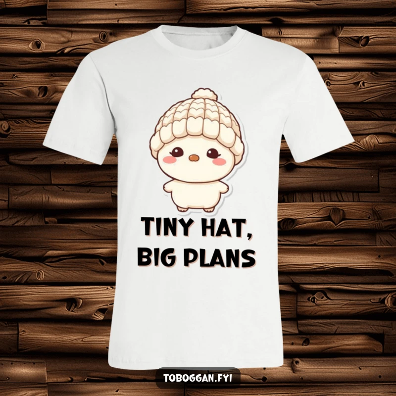 Funny t-shirt showcasing a character with a mischievous grin and a tiny wool hat, embodying playful mischief and lighthearted fun.