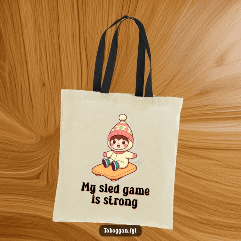 Funny tote bag illustrating a character in a funny hat, enjoying a thrilling toboggan ride down a snow-covered hill.